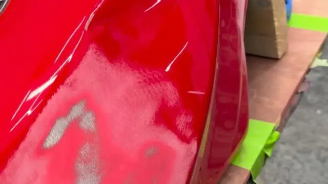 A dented motorbike fuel tank being repaired by Perfect Detail