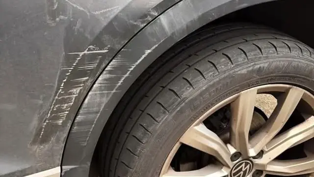 Close-up of a scratched and creased VW rear door and wheel arch, the kind of photo that helps with a quote